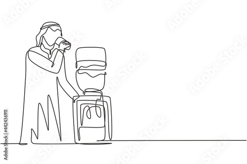 Single continuous line drawing young Arabian man drinking fresh water in glass while standing next to water dispenser filled with gallons of water. One line draw graphic design vector illustration