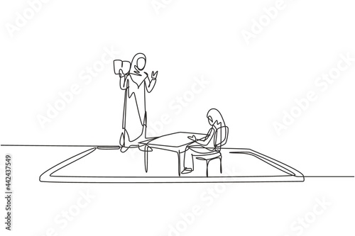 Single continuous line drawing hijab female teacher teaching female junior high school student who sits on bench around desk and studies on smartphone. One line draw graphic design vector illustration
