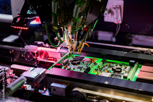 Electronic circuit board production and computer chip fly test by robotic automated machine