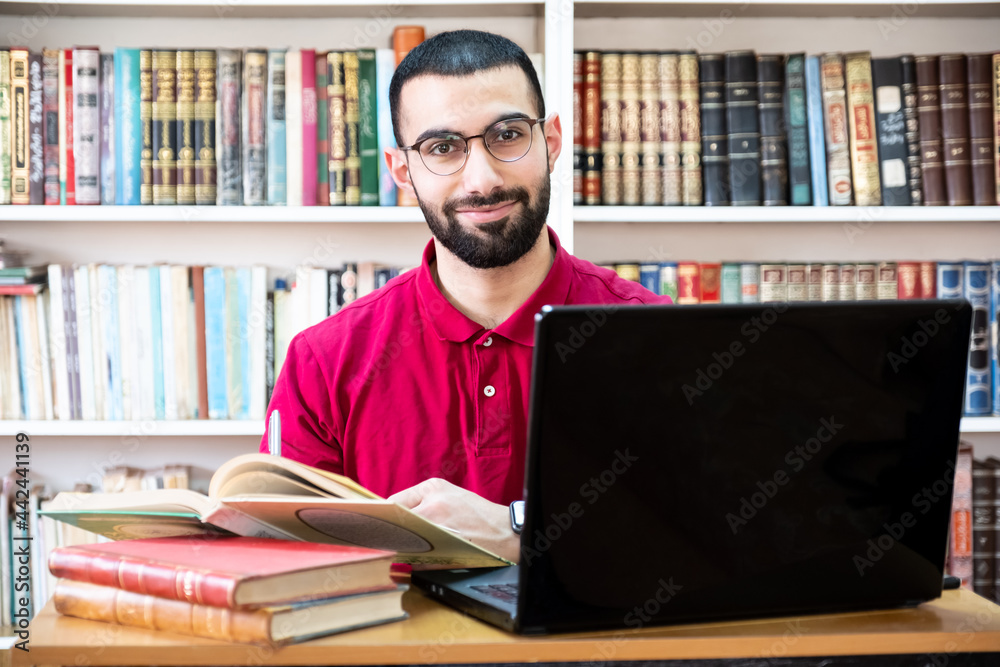 Arabic man using a laptop during conferences or meetings for studying and teaching through online channels Arabic man using a laptop during conferences or meetings for studying and teaching through online channels