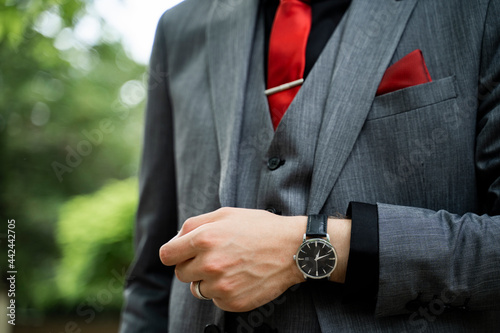 Detail shot of elegant man in suit and tie and wrist watch 