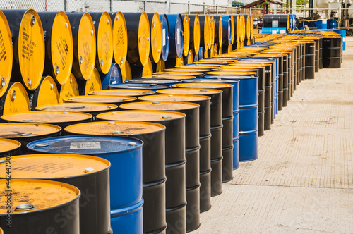 Industry oil barrels or chemical drums stacked up.container of barrels of hydrocarbons.hazardous waste of black and blue tank oil.Stack Of Oil barrels in plant.
