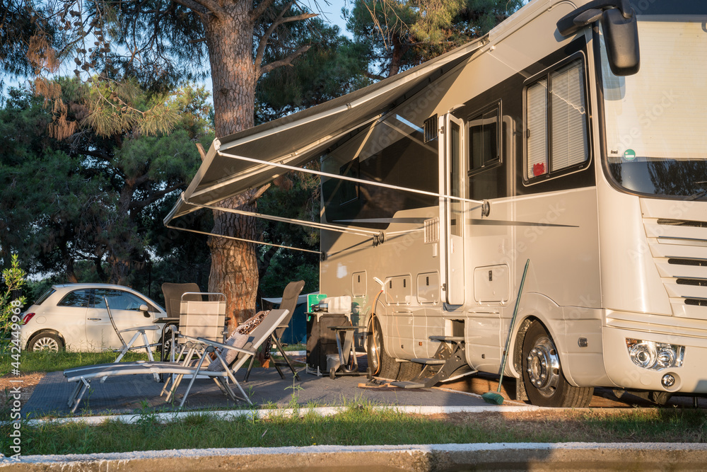 Luxurious caravan holiday concept at the campsite in the pine trees
