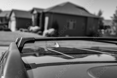Narrow selective focus on the roof rack with cross bars installed on top of a vehicle