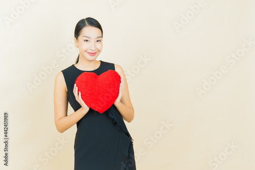 Portrait beautiful young asian woman smile with heart pillow shape