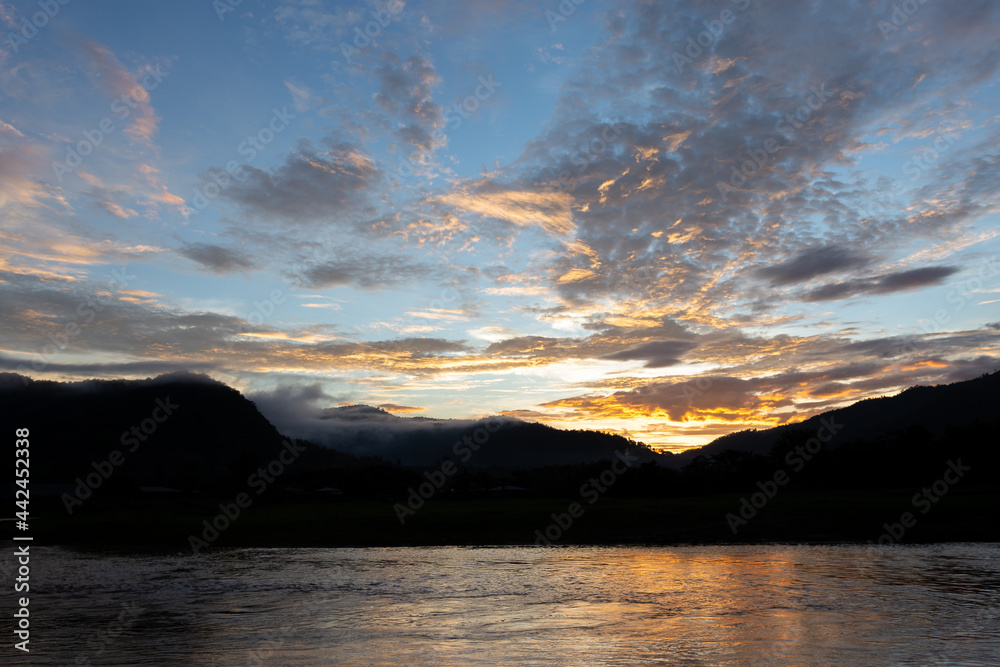 landscape river mountain sky orange clouds sunset evening mountain silhouette for refreshing background