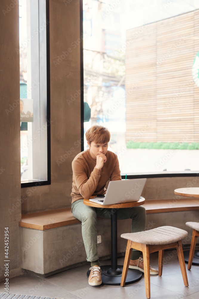 Young man studying and reading at the coffee shop Young man studying and reading at the coffee shop