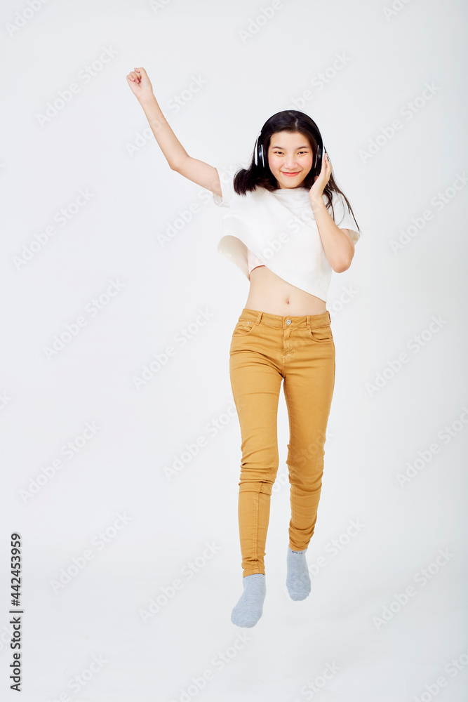 woman with headphones and jumping on  background