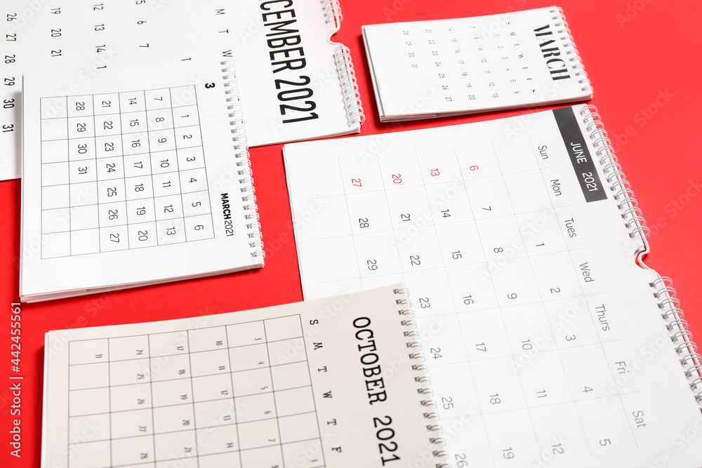 Flip paper calendars on color background, closeup Flip paper calendars on color background, closeup