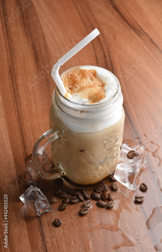 ice cafe mocha latte drink with bubbles and coffee bean in glass on wood table coffee beverage menu
