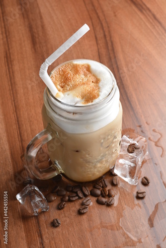 ice cafe mocha latte drink with bubbles and coffee bean in glass on wood table coffee beverage menu