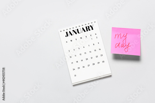 Flip paper calendar and sheet of paper with text MY DAY on light background