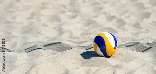 Beach volleyball ball on the sand beach. Team sport concept photo