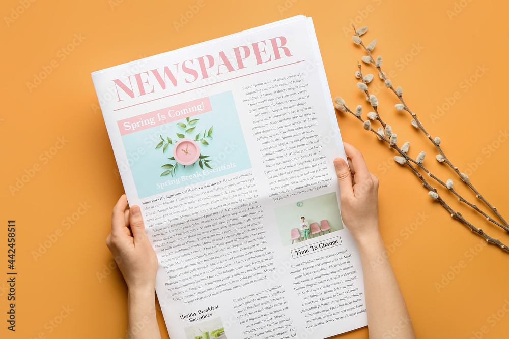 Obraz premium Woman with newspaper and willow branches on color background