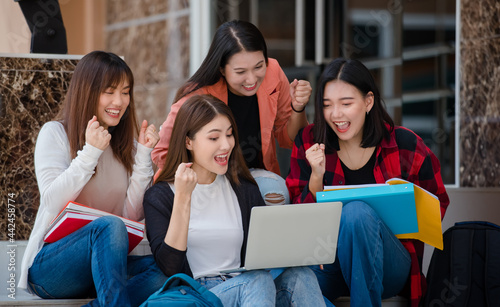 Wallpaper Mural Group of four young attractive asian girls college students studying together using laptop in university campus outdoor. Concept for education, friendship and college students life Torontodigital.ca