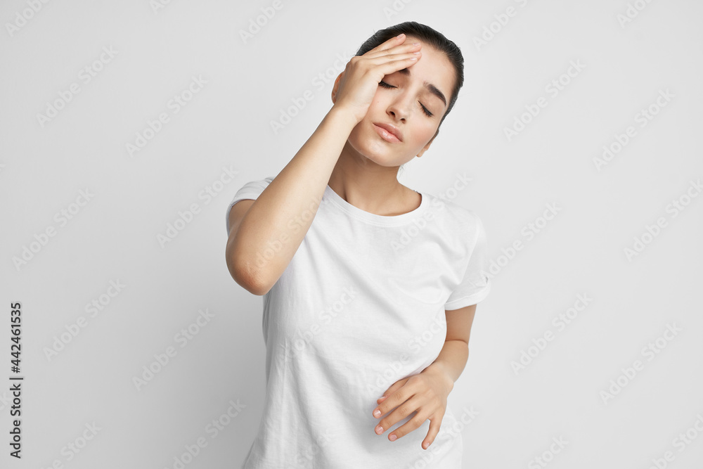 woman in white t-shirt health problems headache stress emotions woman in white t-shirt health problems headache stress emotions