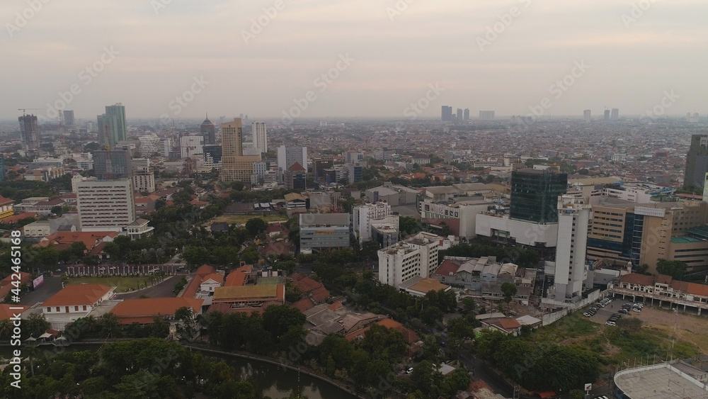 Aerial cityscape modern city Surabaya with skyscrapers, buildings and houses. sunset in city skyline with skyscrapers and business centers Surabaya capital city east java, indonesia