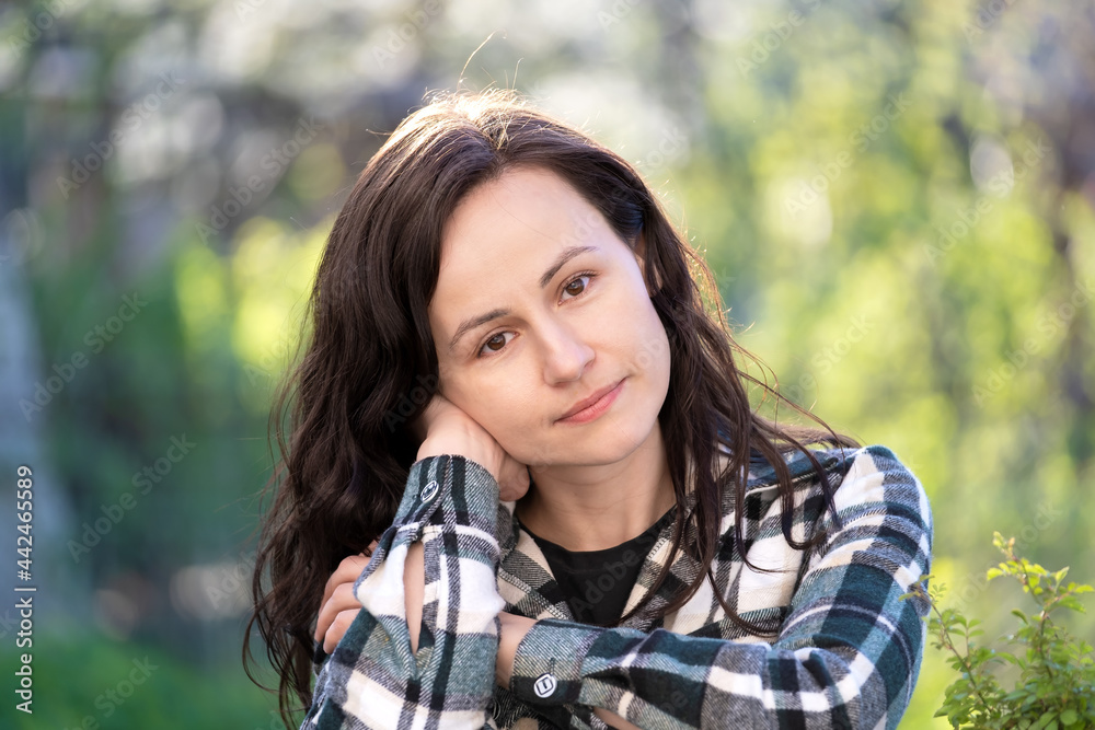 Portrait of thoughtful pretty young woman relaxing outdoors on warm spring sunny day. Portrait of thoughtful pretty young woman relaxing outdoors on warm spring sunny day.
