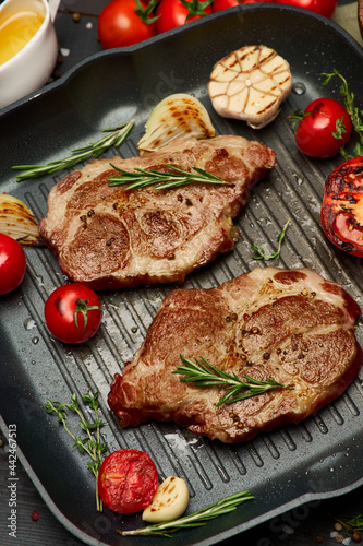 Grilled roated beef steaks on frying pan photo