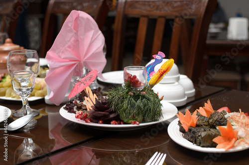 Wallpaper Mural Meat salad decorated with dill a beetroot flower pomegranate seeds an umbrella and a peacock made of paper is on the banquet table Torontodigital.ca