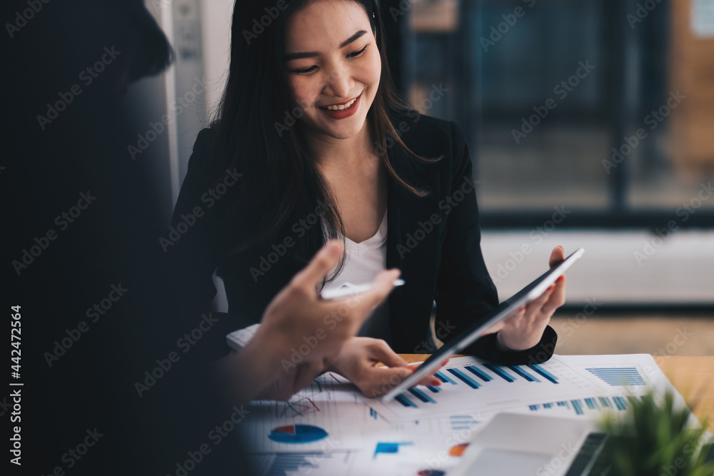 Fototapeta premium Asian business adviser meeting to analyze and discuss the situation on the financial report in the meeting room.Investment Consultant,Financial Consultant,Financial advisor and accounting concept.