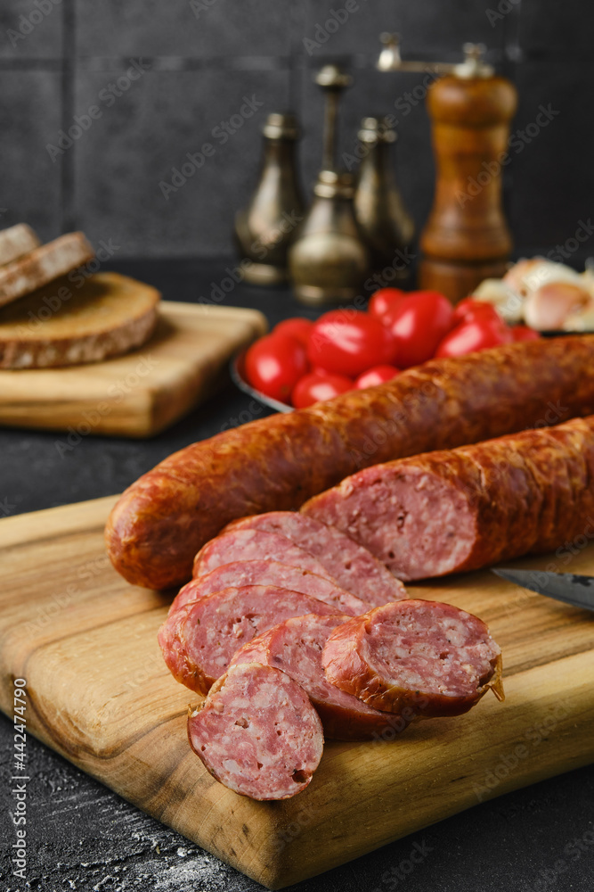 Closeup view of smoked beef sausage rings on wooden cutting board