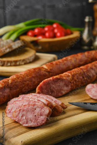 Closeup view of smoked lamb sausage rings on wooden cutting board