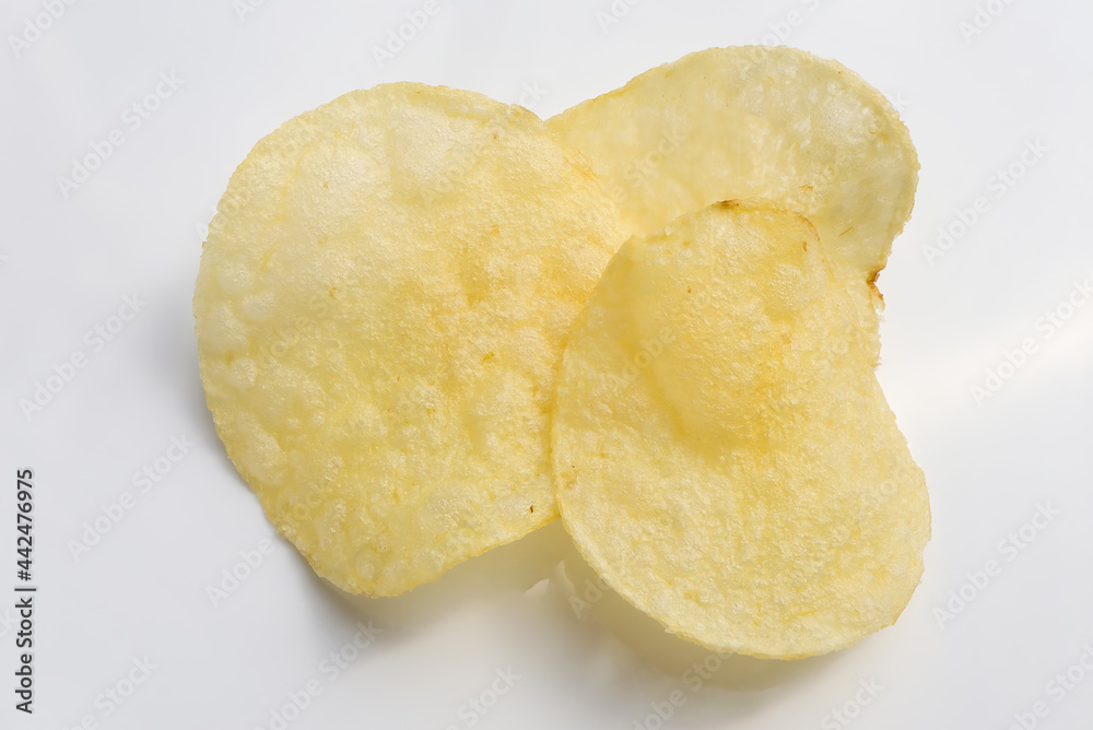 crispy potato chips on white background. crispy potato chips on white background.
