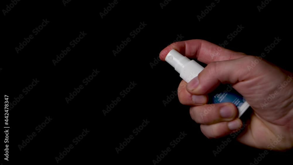 Slow motion spraying a vegan vitamin d spray on isolated black background Slow motion spraying a vegan vitamin d spray on isolated black background