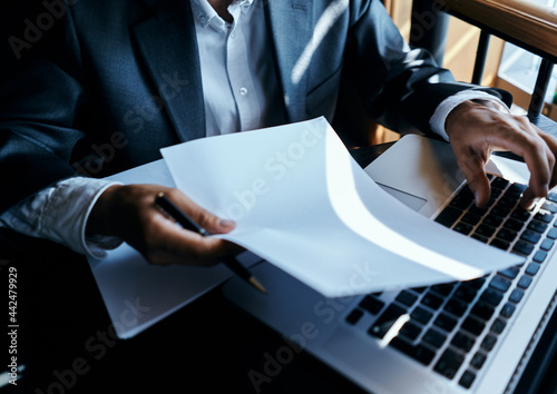 business man sitting at a table in a cafe paper laptop work