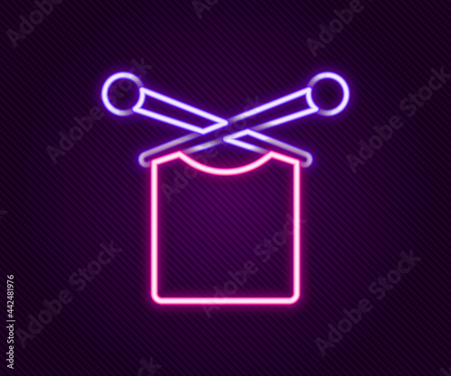 Glowing neon line Knitting icon isolated on black background. Wool emblem with knitted fabric and needle. Label for hand made, knitting or tailor shop. Colorful outline concept. Vector