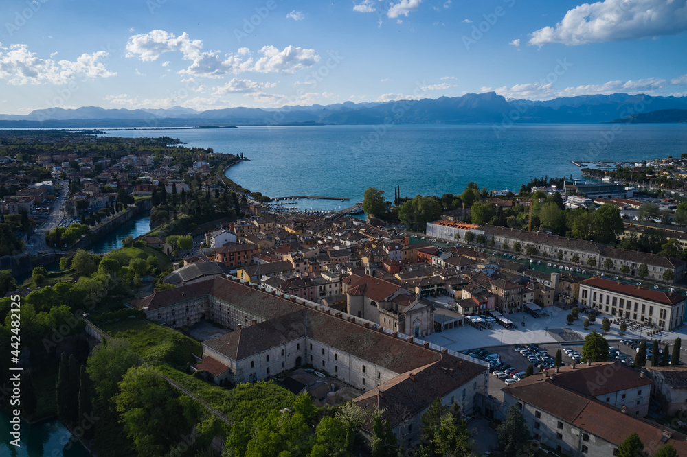 Aerial panorama of the city of Peschiera del Garda on Lake Garda, Italy. The city of peschiera del garda at sunset. Aerial view of a tourist town in Italy. Italian resorts on Lake Garda.