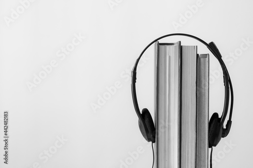 Abstract Book with earphone. E book, Audio Book. Shoot in Black and white color background. Lifestyle concept. 