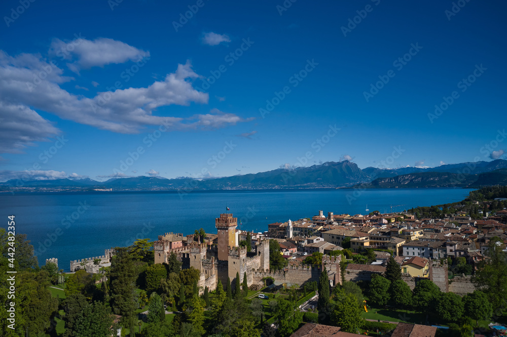 Fototapeta premium Lazise Lake Garda Italy. Panorama of the historic town of Lazise. Top view of the historic part of the city Lazise Castle on the coastline of Lake Garda. Aerial view of the Scaliger Castle of Lazise.