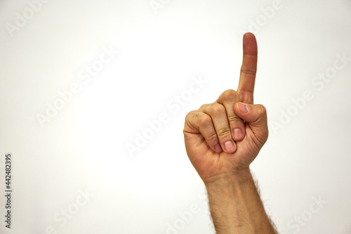 One finger gesture. Show digit. All right. Hand of a Caucasian man on a white background and place for text.