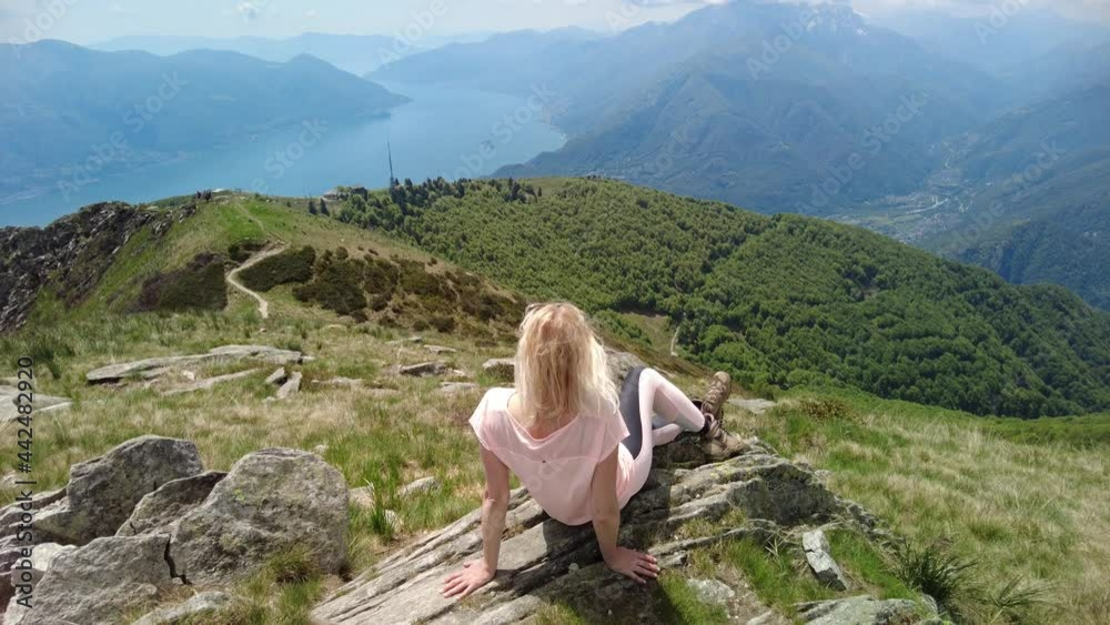 Woman sitting on top of Cardada-Cimetta mount in Switzerland. Swiss ...