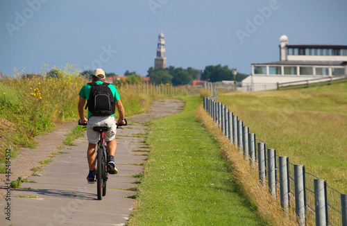 Man cycling in the Netherlands during vacation (Hindeloopen, Frisia) photo