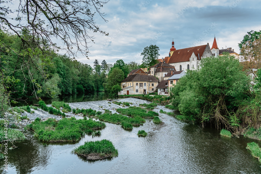 Spring view of beautiful castle,waterfront houses and Nezarka river with weir in town of Straz nad Nezarkou,south Bohemia, Czech republic.Famous Czech opera singer Ema Destinnova lived here