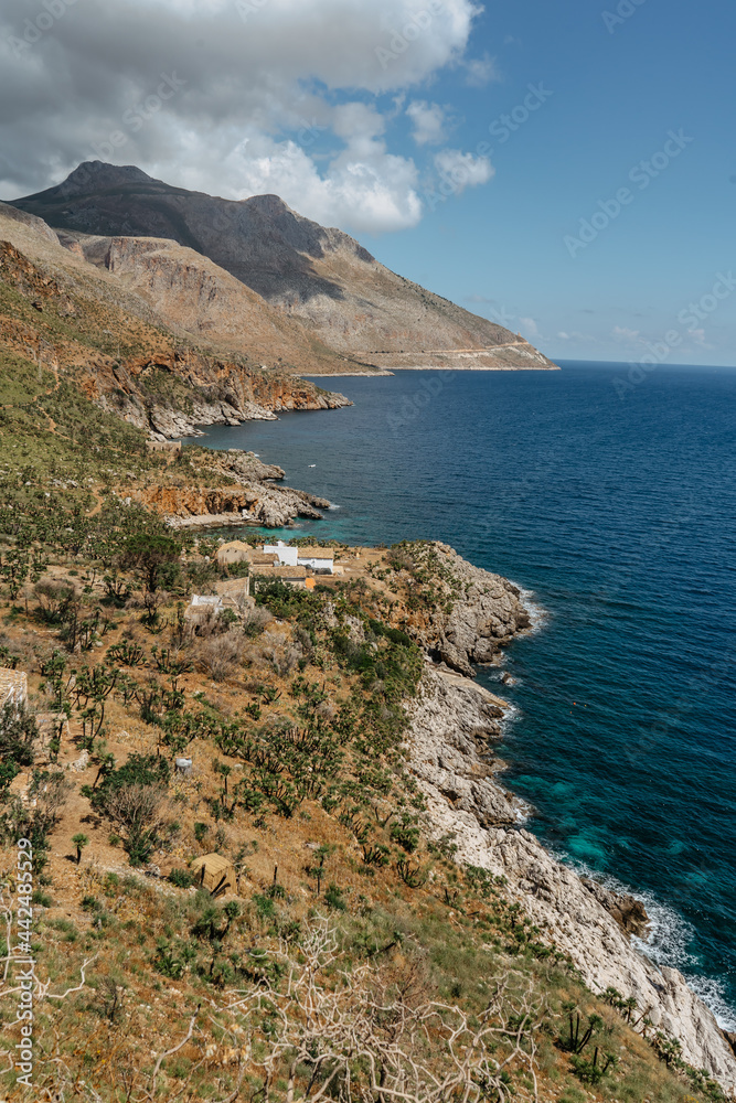 Beach vacation in Italy, Sicily, turquoise water,sandy beaches,hiking trails.Holiday paradise travel scenery.Scenic coastline of Zingaro Nature Reserve with rocks.Beautiful lagoons with clear water.