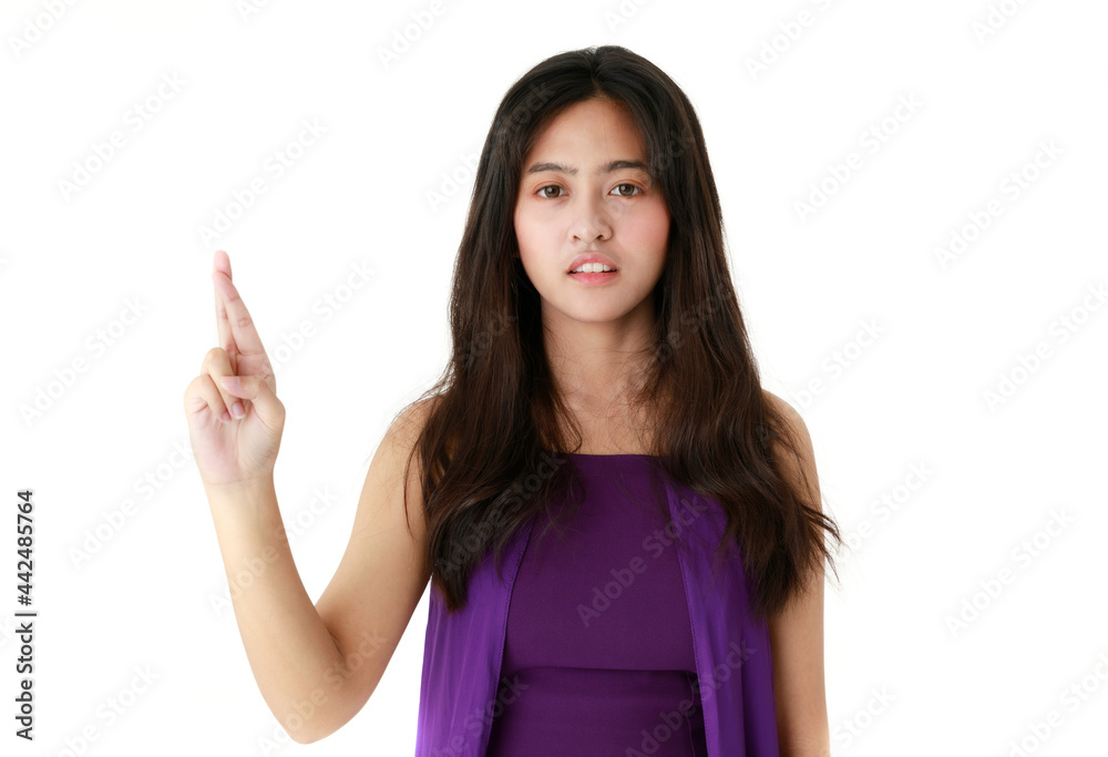 Serene ethnic female pointing up with index finger on white background in studio and looking at camera Serene ethnic female pointing up with index finger on white background in studio and looking at camera