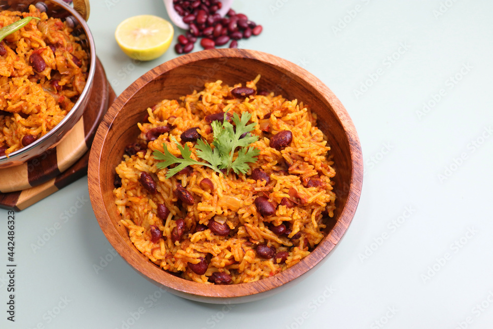 Indian cuisine - Kidney Beans Biryani, Rajma Pulao. Garnished with chopped coriander, and lemon wedges. Rajma biryani served with dahi. Along with copy space. Rajma Chawal flatlay. Indian cuisine - Kidney Beans Biryani, Rajma Pulao. Garnished with chopped coriander, and lemon wedges. Rajma biryani served with dahi. Along with copy space. Rajma Chawal flatlay.