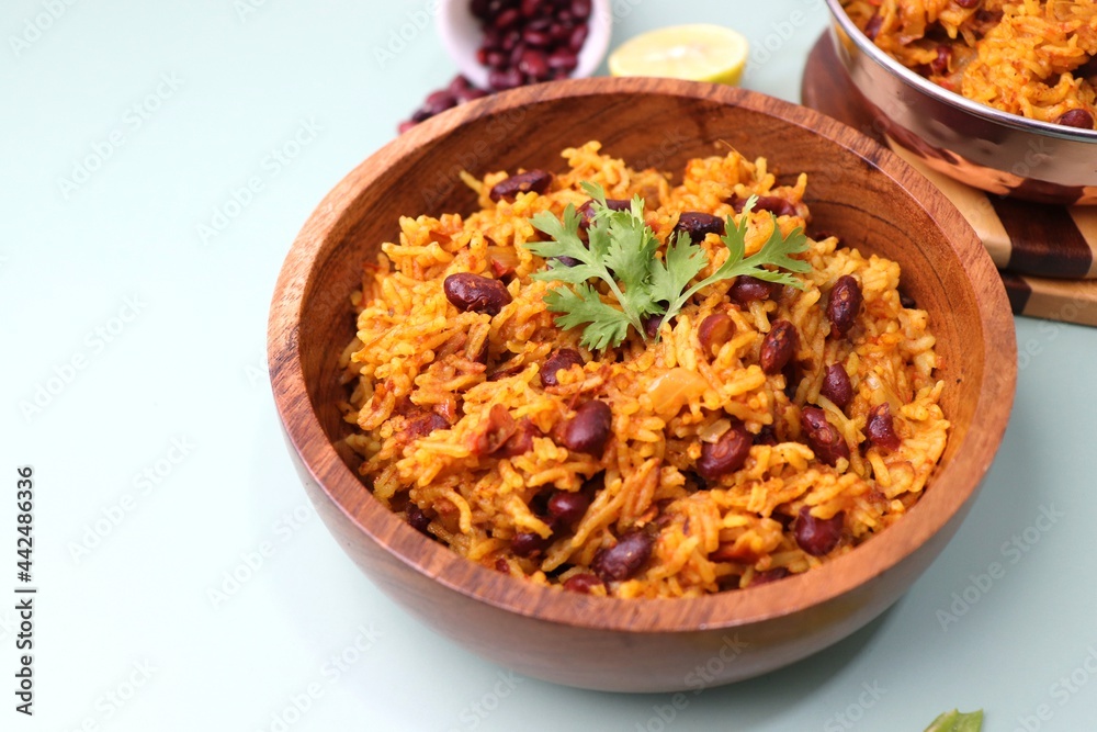 Indian cuisine - Kidney Beans Biryani, Rajma Pulao. Garnished with chopped coriander, and lemon wedges. Rajma biryani served with dahi. Along with copy space. Rajma Chawal flatlay. Indian cuisine - Kidney Beans Biryani, Rajma Pulao. Garnished with chopped coriander, and lemon wedges. Rajma biryani served with dahi. Along with copy space. Rajma Chawal flatlay.