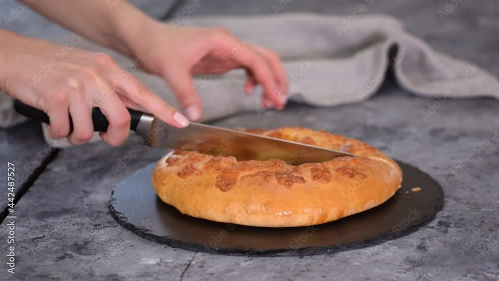Freshly baked khachapuri with cheese on a table. Freshly baked khachapuri with cheese on a table.
