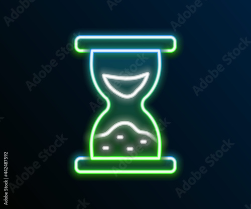 Glowing neon line Old hourglass with flowing sand icon isolated on black background. Sand clock sign. Business and time management concept. Colorful outline concept. Vector