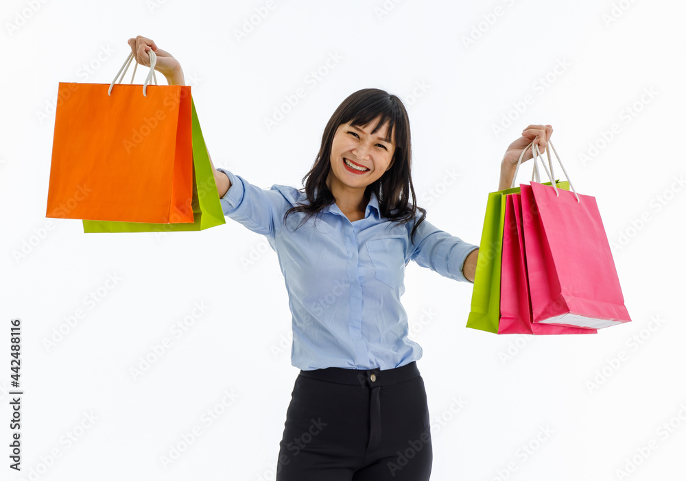 Young lady standing in studio show colorful shopping bags in her hands with big smile seems like she happy to be shopper. Concept buyer,  discount,  lifestyle, purchase, sale, discount, shopaholic.