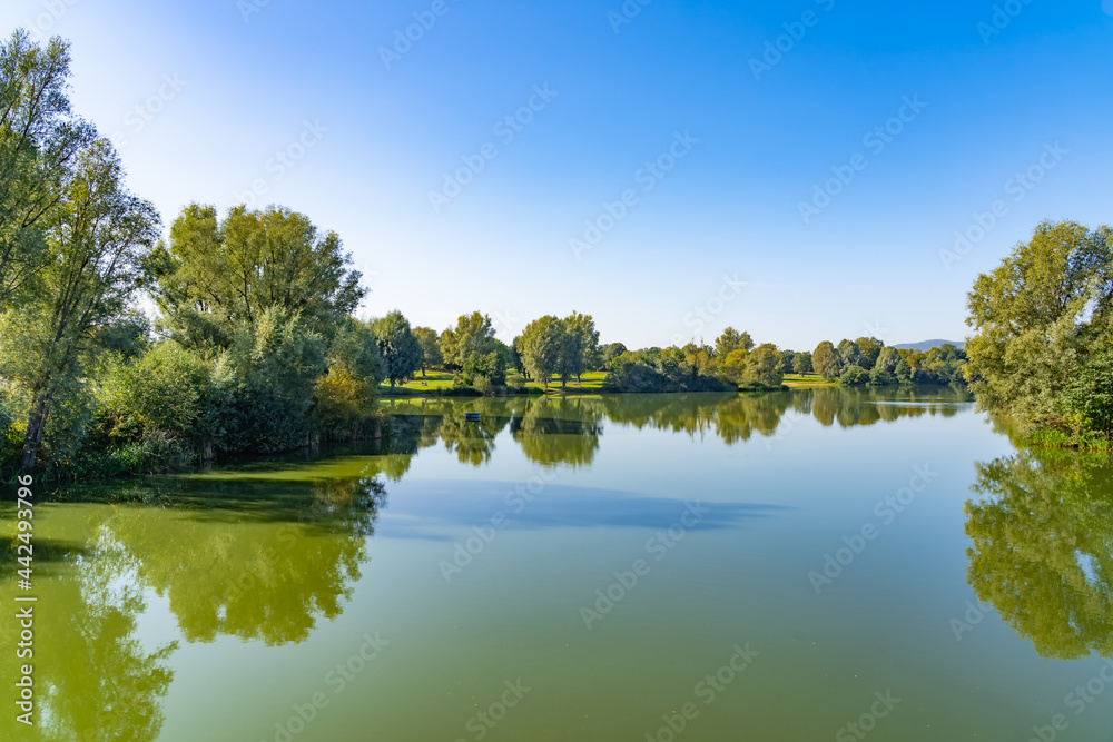 Beautiful panorama of the lake landscape on a summer day in the Fuldaaue in Kassel, Germany