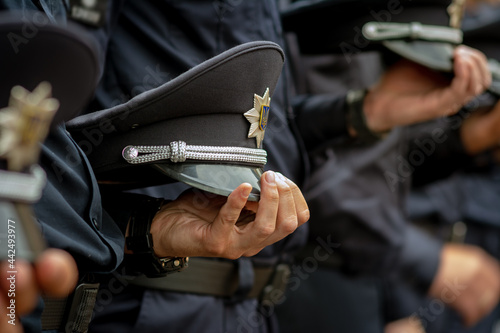 Vászonkép Uniform cap in the hand of Ukrainian policmen