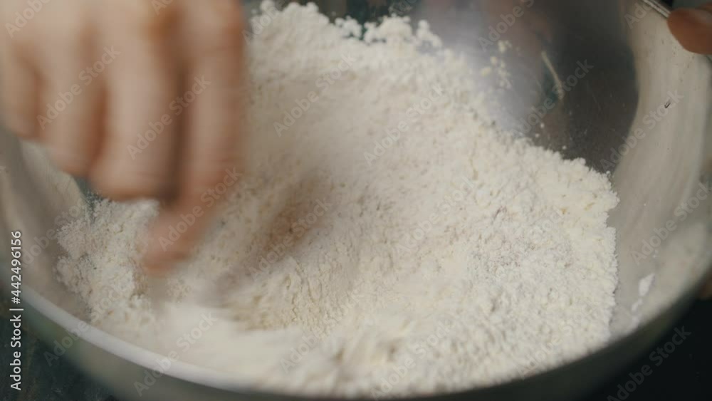 Mixing spices with cooking flour inside deep metal bowl. Mixing spices with cooking flour inside deep metal bowl.