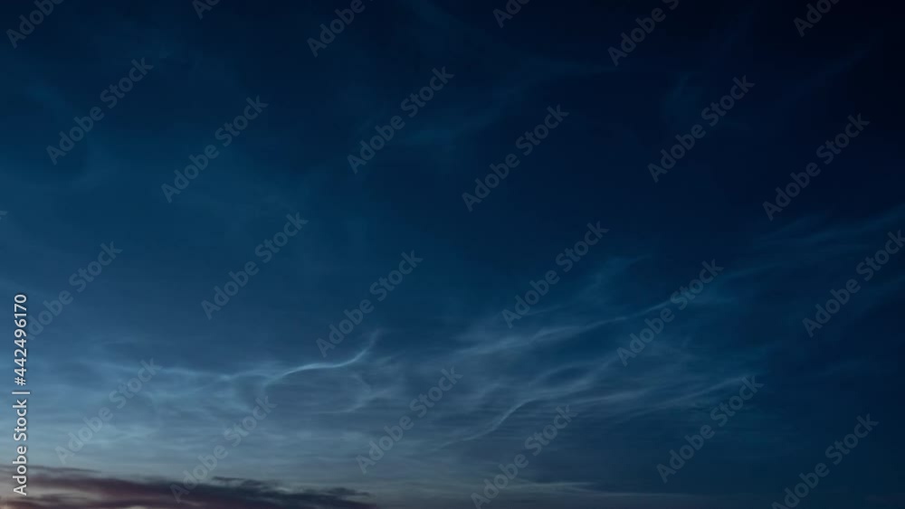Beautiful time lapse of silvery (noctilucent, polar mesospheric) clouds glowing and shining at summer evening, calm and tranquil scenic view, wide angle shot Beautiful time lapse of silvery (noctilucent, polar mesospheric) clouds glowing and shining at summer evening, calm and tranquil scenic view, wide angle shot