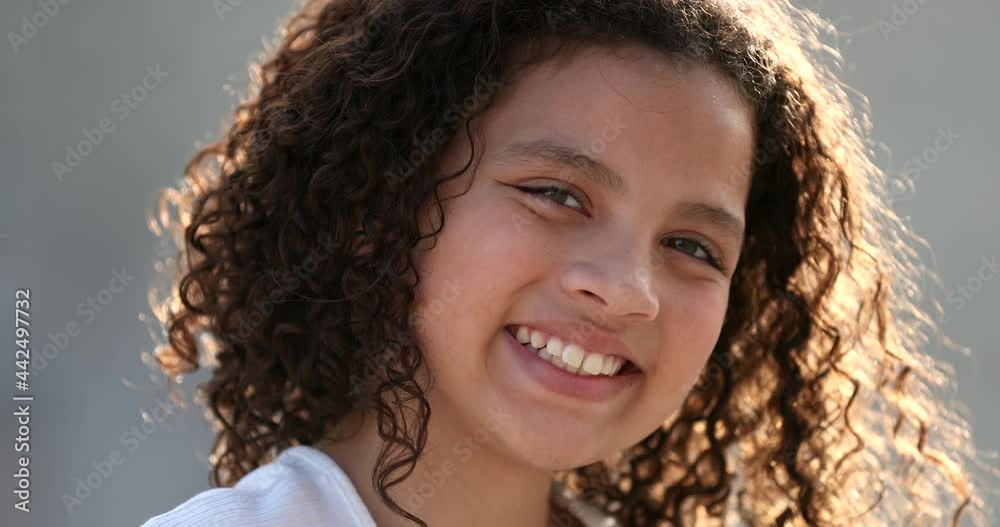 HIspanic little girl child portrait face close-up smiling outside